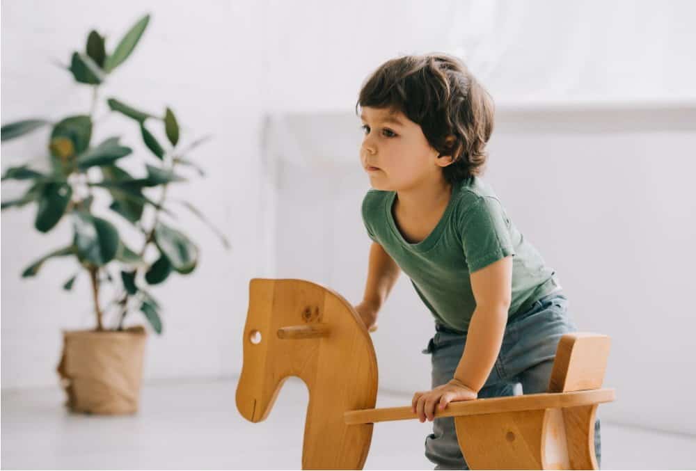 Toddler with wooden push walker